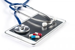 Pills and Stethoscope with Tablet Capsule on Touch Screen Mobile Phone